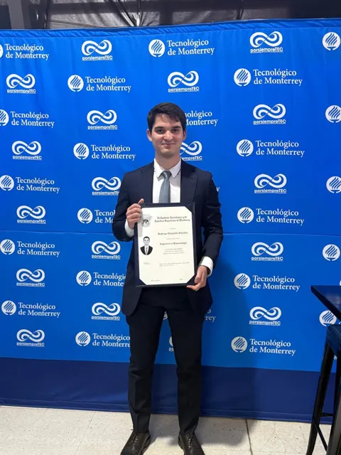 Rodrigo holding his biotechnology degree at Tec
