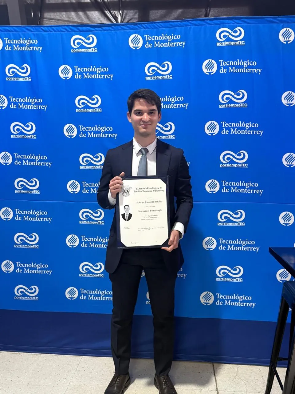 Graduation portrait holding a Biotechnology Engineering diploma at Tecnológico de Monterrey